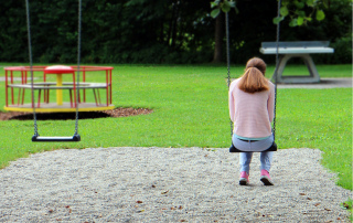 woman alone on swings in park
