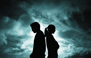 Sihoutte of couple standing back to back