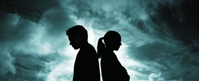 Sihoutte of couple standing back to back