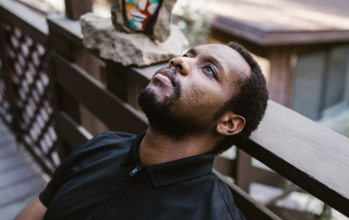 Man leaning back staring into space