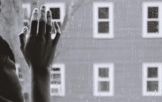 Hand on window pane