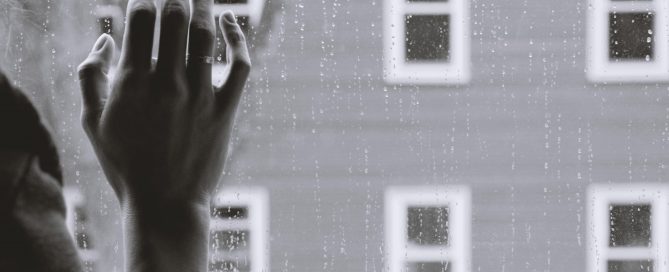 Hand on window pane